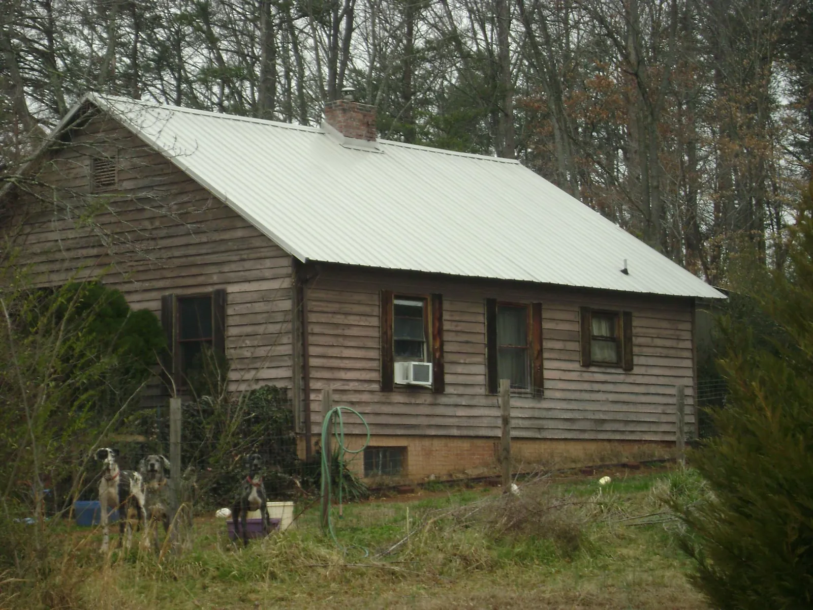 White metal roof on an old wood sided farmhouse, from a Metal Roof Installation job in Delano